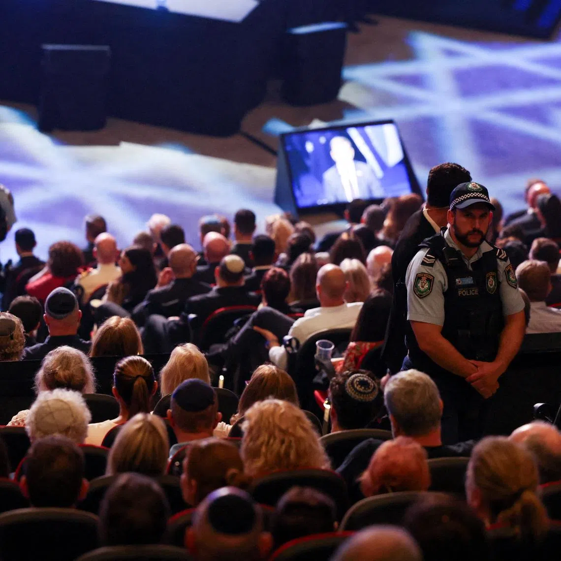 Security personnel stand guard at 'An Evening of Light & Solidarity', during Israeli President Isaac Herzog's state visit to Australia, in Sydney, Australia, February 9, 2026. REUTERS/Hollie Adams