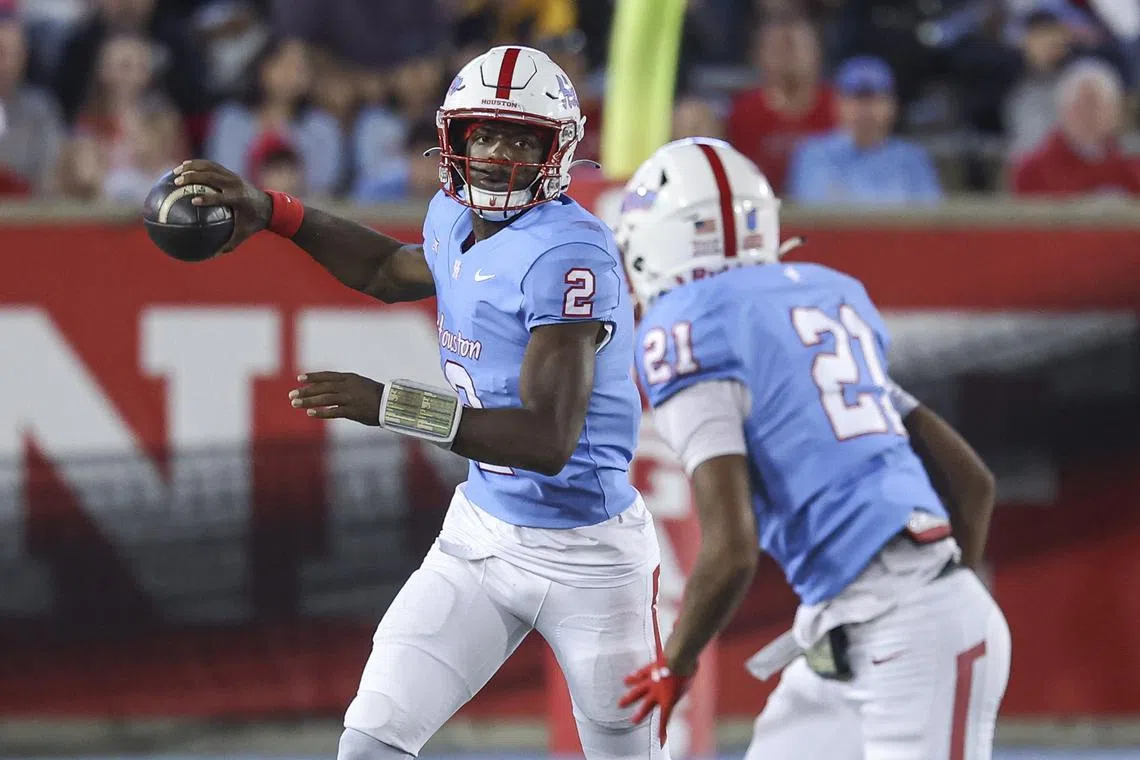 Nov 23, 2024; Houston, Texas, USA; Houston Cougars quarterback Zeon Chriss (2) looks to throw the ball to running back Stacy Sneed (21) during the third quarter against the Baylor Bears at TDECU Stadium. Mandatory Credit: Troy Taormina-Imagn Images/ File photo
