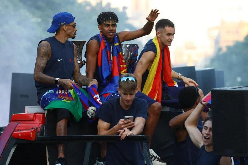 FC Barcelona's Lamine Yamal (centre) during the bus parade on May 11 as they celebrate winning La Liga championship.