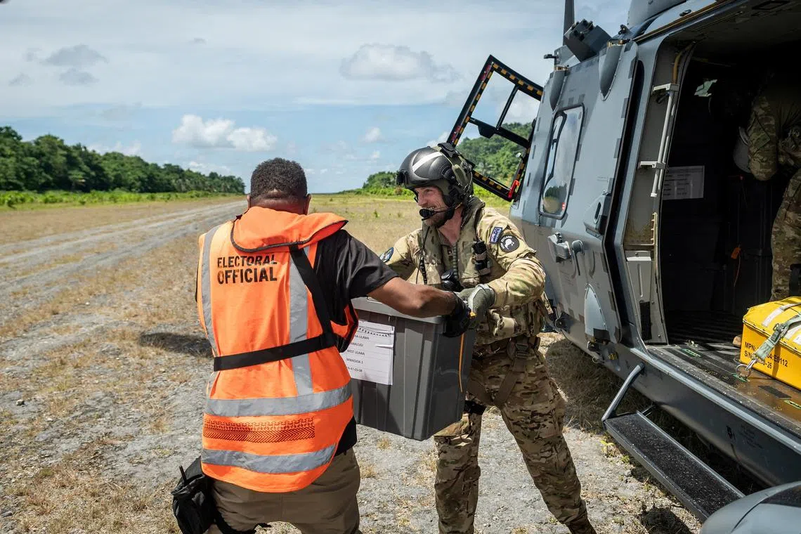 FILE PHOTO: Members of the New Zealand Defence Force (NZDF) Joint Task Force assist in delivering ballot boxes by NH90 helicopter to remote areas of the Solomon Islands ahead of the upcoming election, Solomon Islands, in this handout image released on April 17, 2024. New Zealand Defence Force/Handout via REUTERS/File Photo