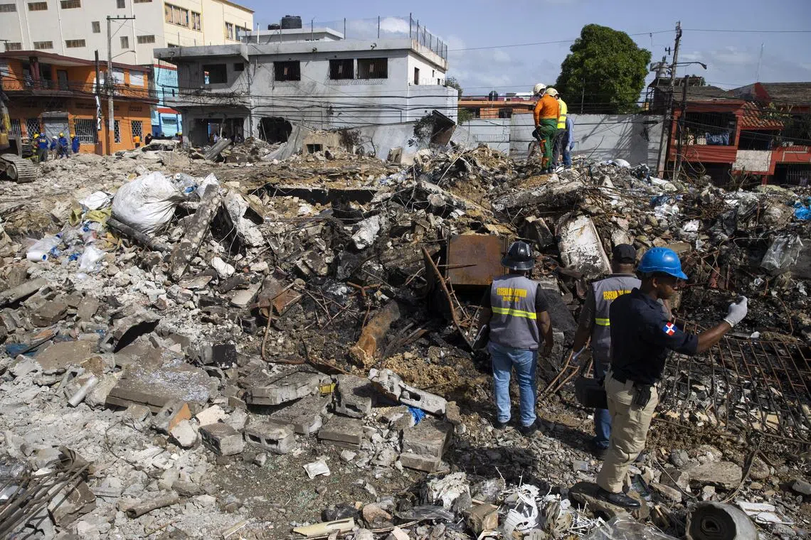 Rescue workers search for missing people a day after the blast in the city of San Cristobal.