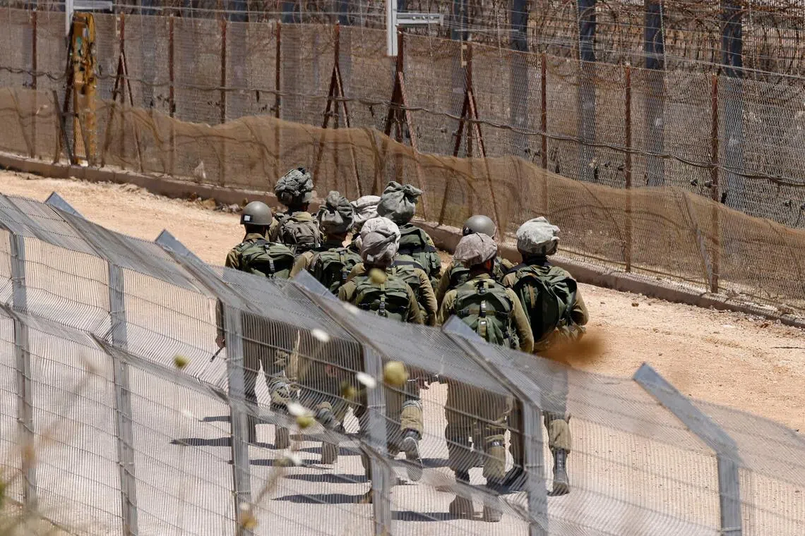 Israeli troops patrolling the border fence with Syria in the Israel-annexed Golan Heights on July 26.