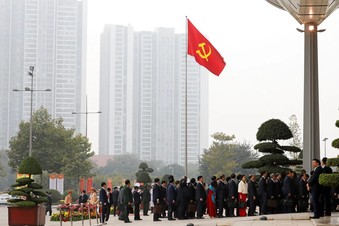 Delegates arrive under a communist flag for the opening ceremony of the 13th national congress of the communist party of Vietnam at the National Convention Center in Hanoi, Vietnam January 26, 2021. REUTERS/Kham/File Photo