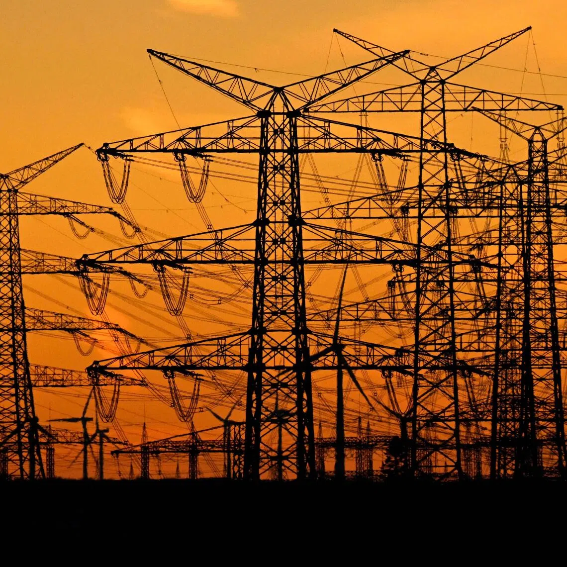 Electricity pylons near a German power station. Germany - Europe’s largest economy - is only the third country to have unveiled a roadmap for abandoning fossil fuels after France and the Netherlands.