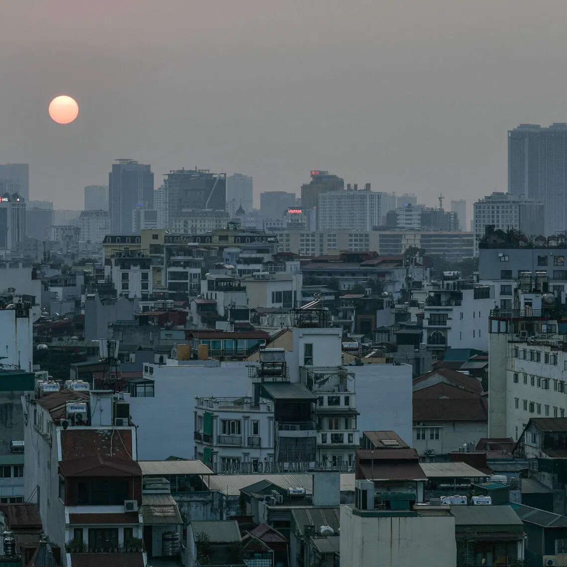 A general view shows the sun setting over the skyline in the old quarter of Hanoi on Feb 20.