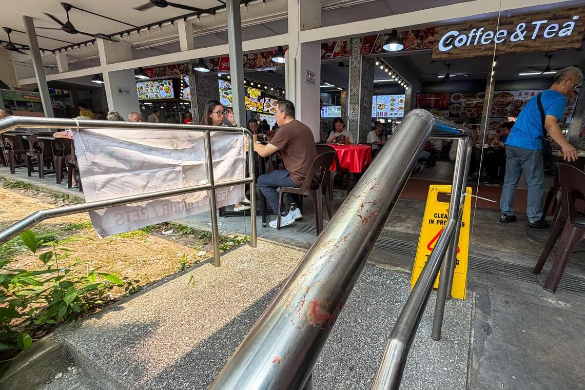 Dried bloodstains on a railing beside a coffee shop at 61 Telok Blangah Heights on Oct 6, near where a stabbing incident is believed to have occurred the previous evening.