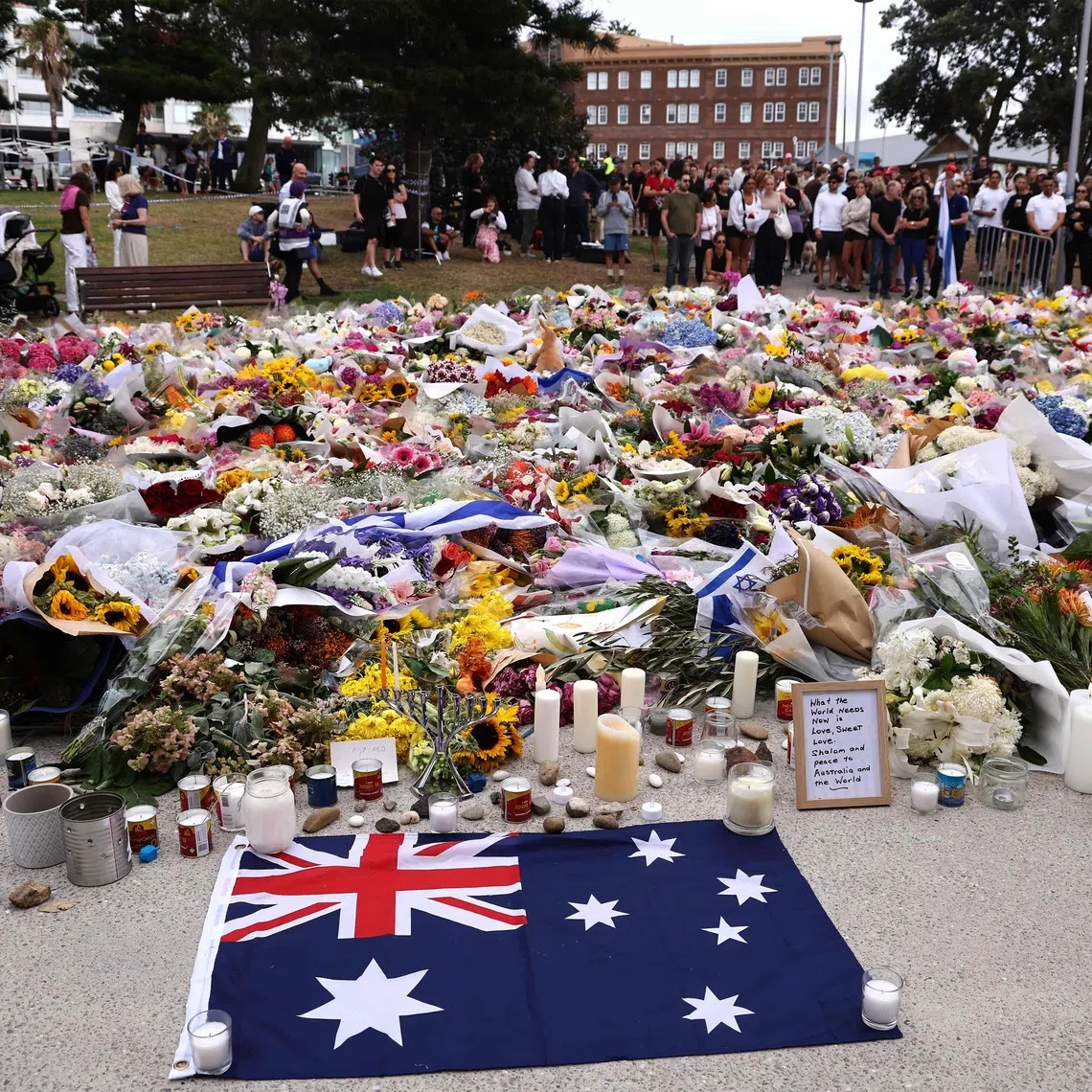 Mourners gather around floral tributes at Bondi Pavilion to honour the victims of the Bondi Beach shooting in Sydney on Dec 16.