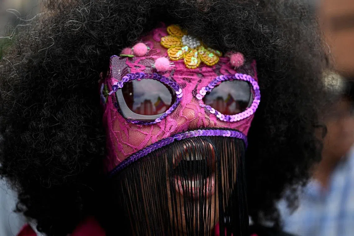 A masked woman shouting slogans during a demonstration on International Women's Day in Caracas, Venezuela on March 8, 2026. 