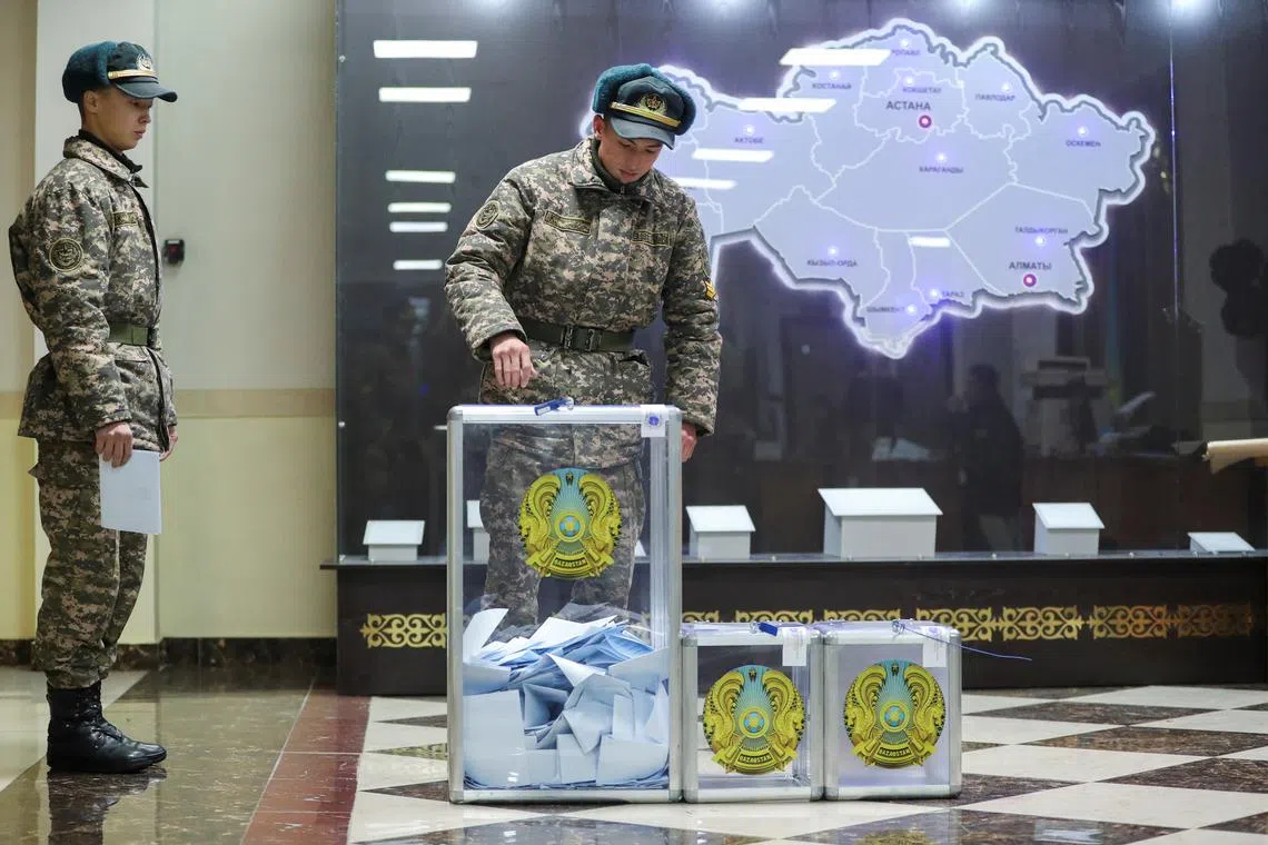 Kazakh army service members cast their votes at a polling station in Almaty, Kazakhstan, on Nov 20, 2022. 