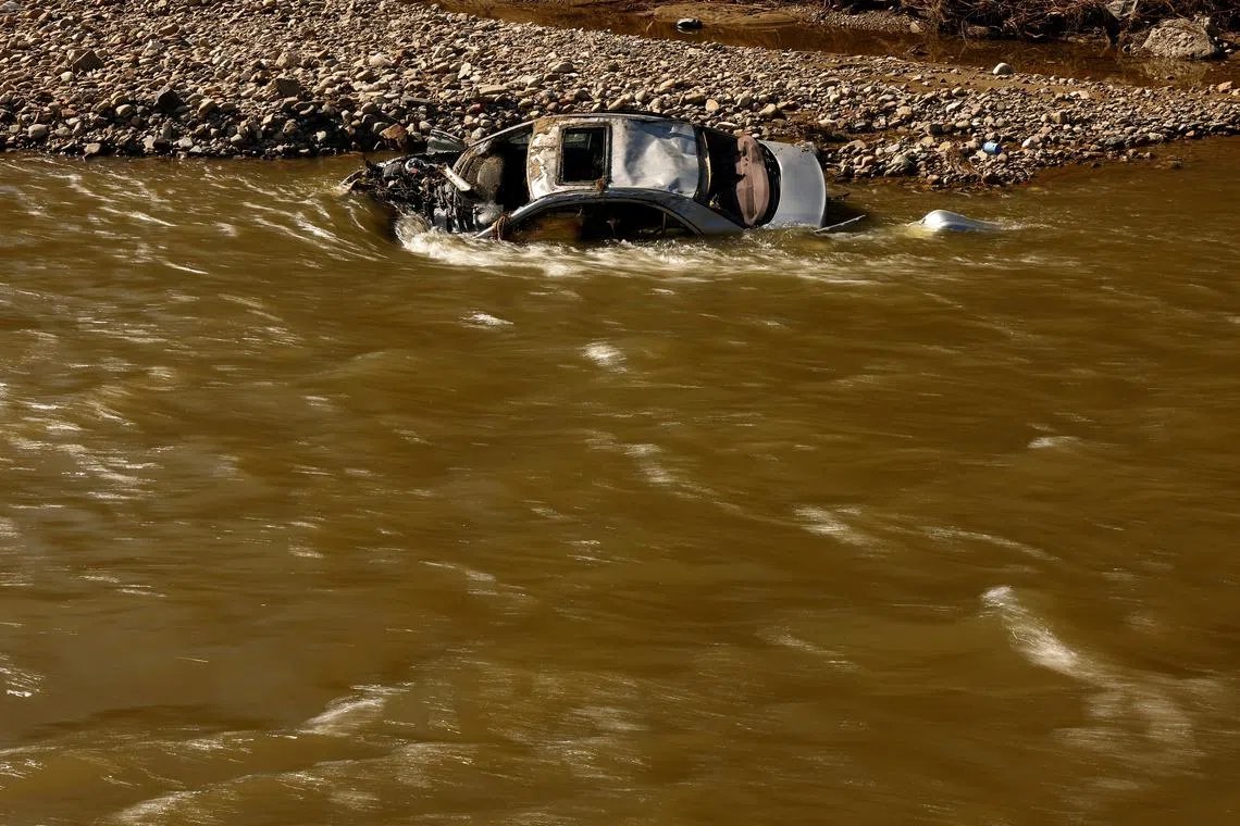 FILE PHOTO: Destroyed car at the Biala Ladecka river lies submerged after flooding in Zelazno, Poland, September 20, 2024. REUTERS/Kacper Pempel/File Photo