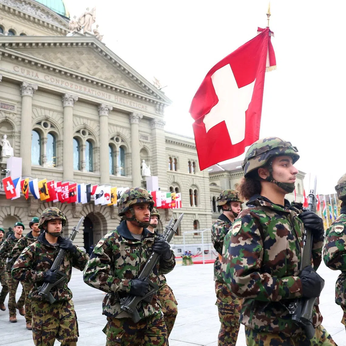 FILE PHOTO: Soldiers from the Swiss army's Infantry Readiness Company 104/1 and the Guard of Honour march past the Swiss Parliament building ahead of the state visit of South African President Cyril Ramaphosa at Federal Square in Bern, Switzerland, October 29, 2025. REUTERS/Denis Balibouse/File Photo