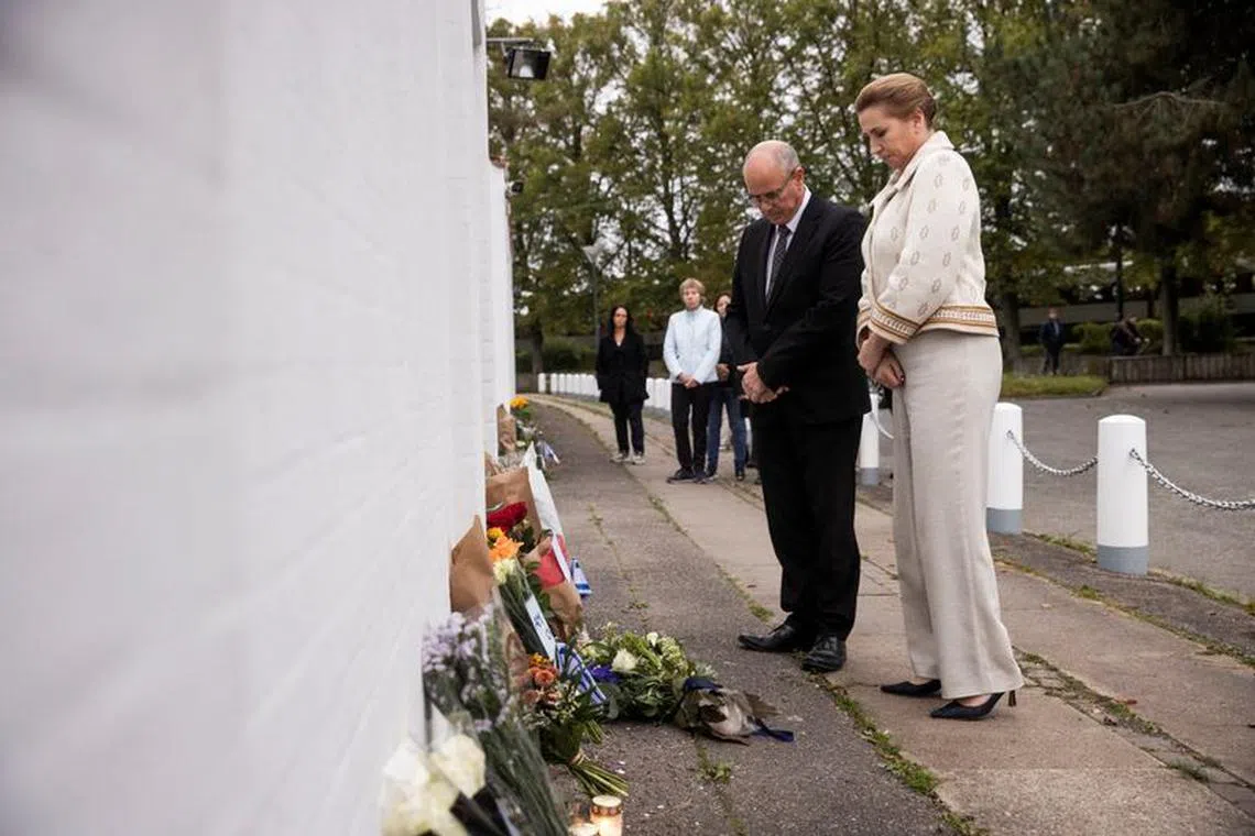 Danish Prime Minister Mette Frederiksen lays flowers at Israel's Embassy, accompanied by Israel's ambassador David Akov, in Copenhagen, Denmark October 10, 2023. Mette Frederiksen has previously emphasised that Denmark stands behind Israel. Ritzau Scanpix/Olafur Steinar Rye Gestsson via REUTERS