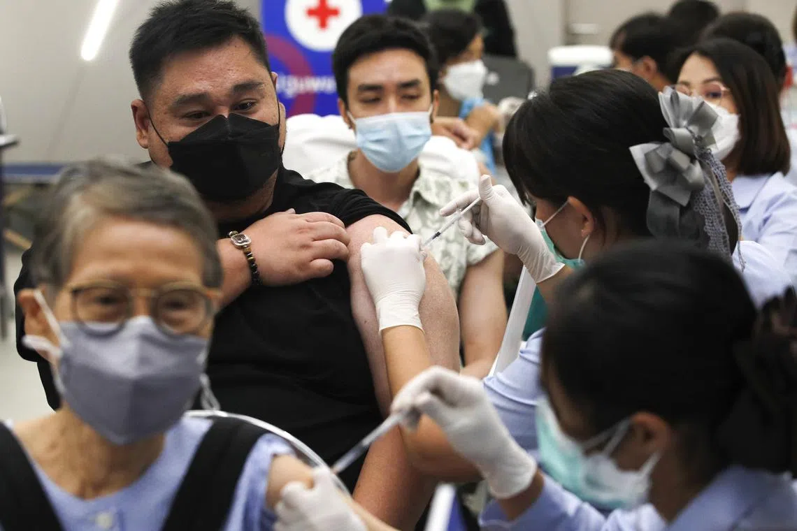 People receive vaccine booster shots against Covid-19 at a vaccination centre in Bangkok, Thailand.