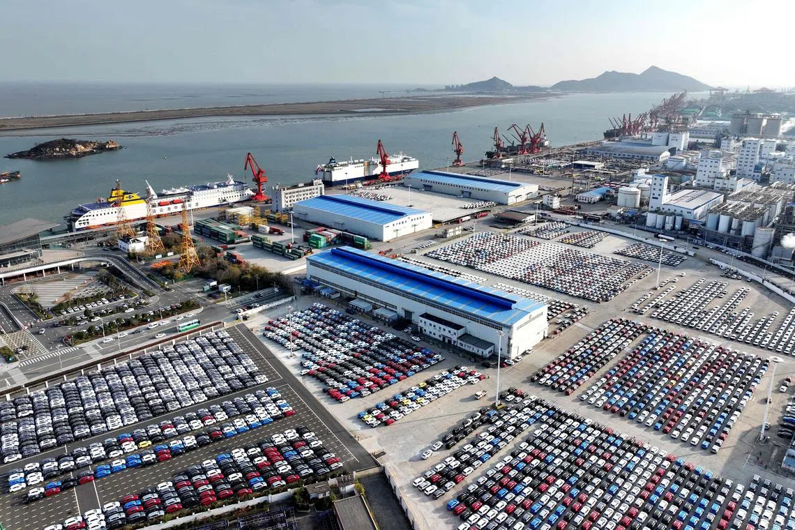 An aerial view shows cars and pickups on the dock waiting to be loaded onto ships for export at the port in Lianyungang, in China’s eastern Jiangsu province on Dec 12, 2024. 