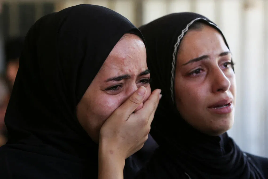 People mourn Palestinians who were killed in an incident on Wednesday while seeking aid in Khan Younis, at Nasser hospital in Khan Younis in the southern Gaza Strip July 16, 2025. REUTERS/Hatem Khaled