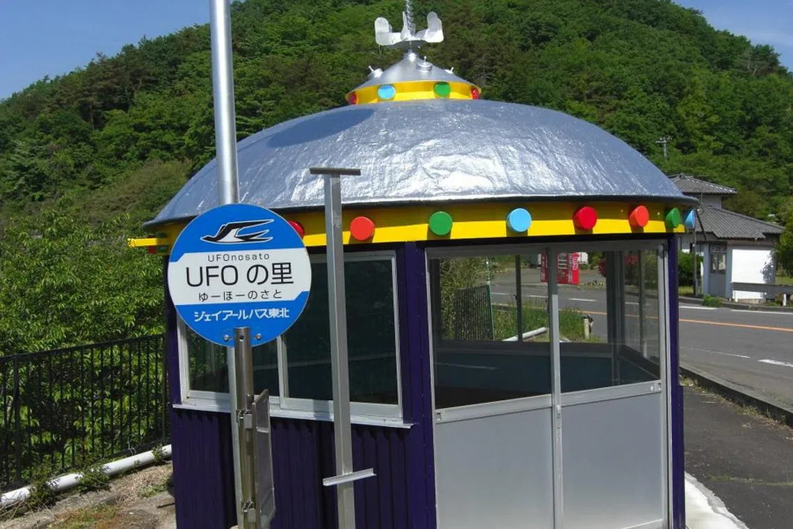 Visitors to Iinomachi, Fukushima prefecture, are greeted with UFO-shaped street lights, flags, bus stops and even an alien statue.