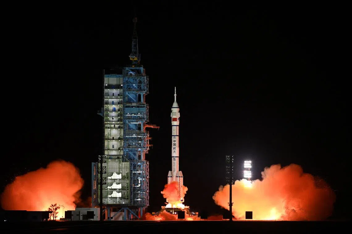 TOPSHOT - A Long March-2F carrier rocket, carrying the Shenzhou-15 spacecraft with three astronauts to China's Tiangong space station, lifts off from the Jiuquan Satellite Launch Center in Northwest China’s Gansu Province late on November 29, 2022. - China launched the Shenzhou-15 spacecraft on November 29, 2022 carrying three astronauts to its space station, where they will complete the country's first-ever crew handover in orbit, state news agency Xinhua reported. (Photo by CNS / AFP) / China OUT