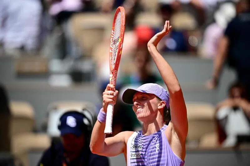 Poland's Iga Swiatek acknowledging the crowd as she celebrates her victory in her women's singles match against Australia's Emerson Jones on day 2 of the French Open tennis tournament.