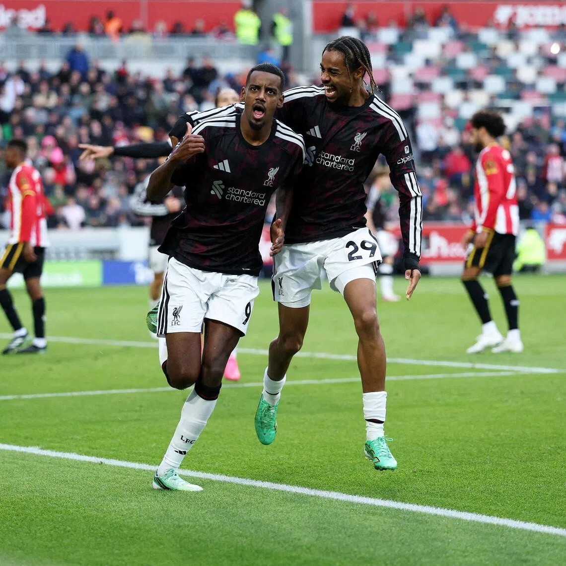 Liverpool’s Alexander Isak celebrates scoring their second goal with Bradley Barcola.