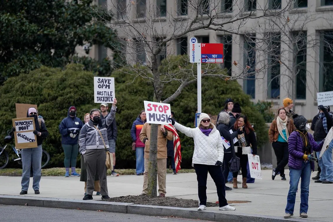People protesting outside the Office of Personnel Management (OPM) headquarters after the Elon Musk-led Department of Government Efficiency (DOGE) was charged with oversight of OPM, in Washington on Feb 2. 