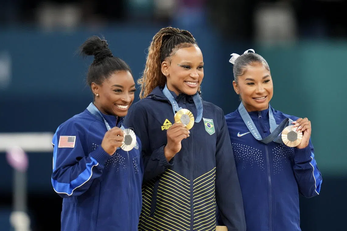 From left: Silver medalist Simone Biles of the US, gold medalist Rebeca Andrade of Brazil and bronze medallist Jordan Chiles of the US at the medal ceremony after the women's floor exercise final.