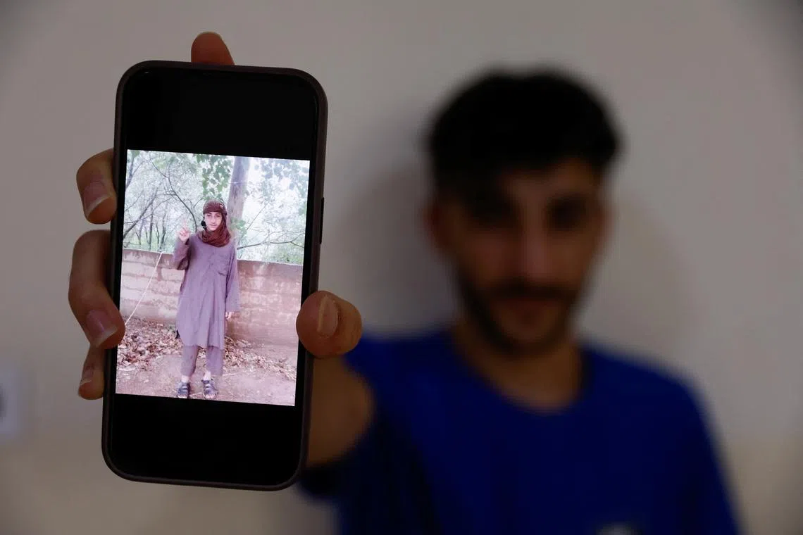 Fahad Qasim, 21, Yazidi survivor holds a phone displaying a picture taken during the time he was kidnapped by Islamic state in Syria, in Duhok, Iraq, June 8, 2024. REUTERS/Khalid Al-Mousily