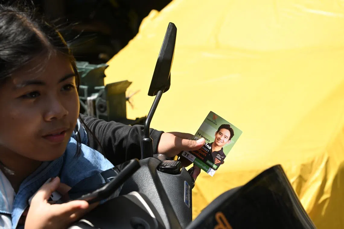 Campaign cards featuring Pita Limjaroenrat, Move Forward's candidate for prime minister, were distributed during his visit to the slum area in Khlong Toei together with the MP candidate for the area Panthil Nuamjerm on May 13.on May 13.