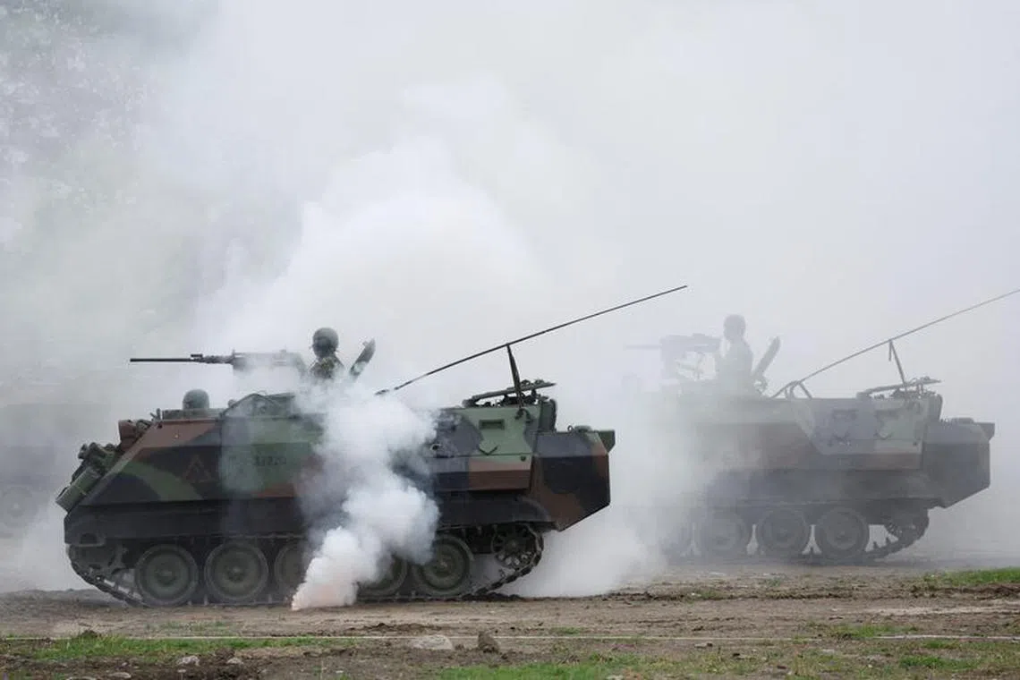 Members of Taiwan's armed forces, riding on armored vehicles, participate in a drill as part of a demonstration for the media to show combat readiness, ahead of the Lunar New Year holidays, at a military base in Taitung, Taiwan January 31, 2024. REUTERS/Carlos Garcia Rawlins