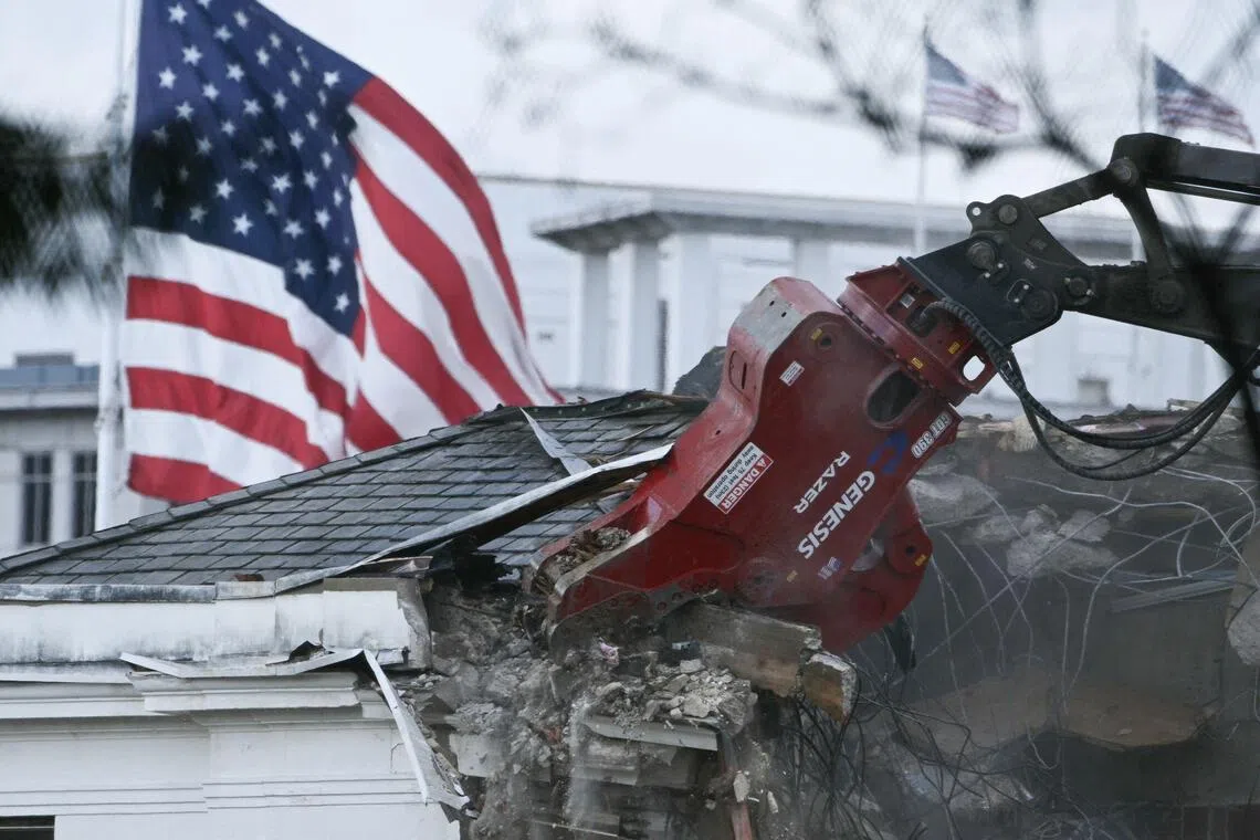Heavy machinery tearing down a section of the East Wing of the White House on Oct 22.