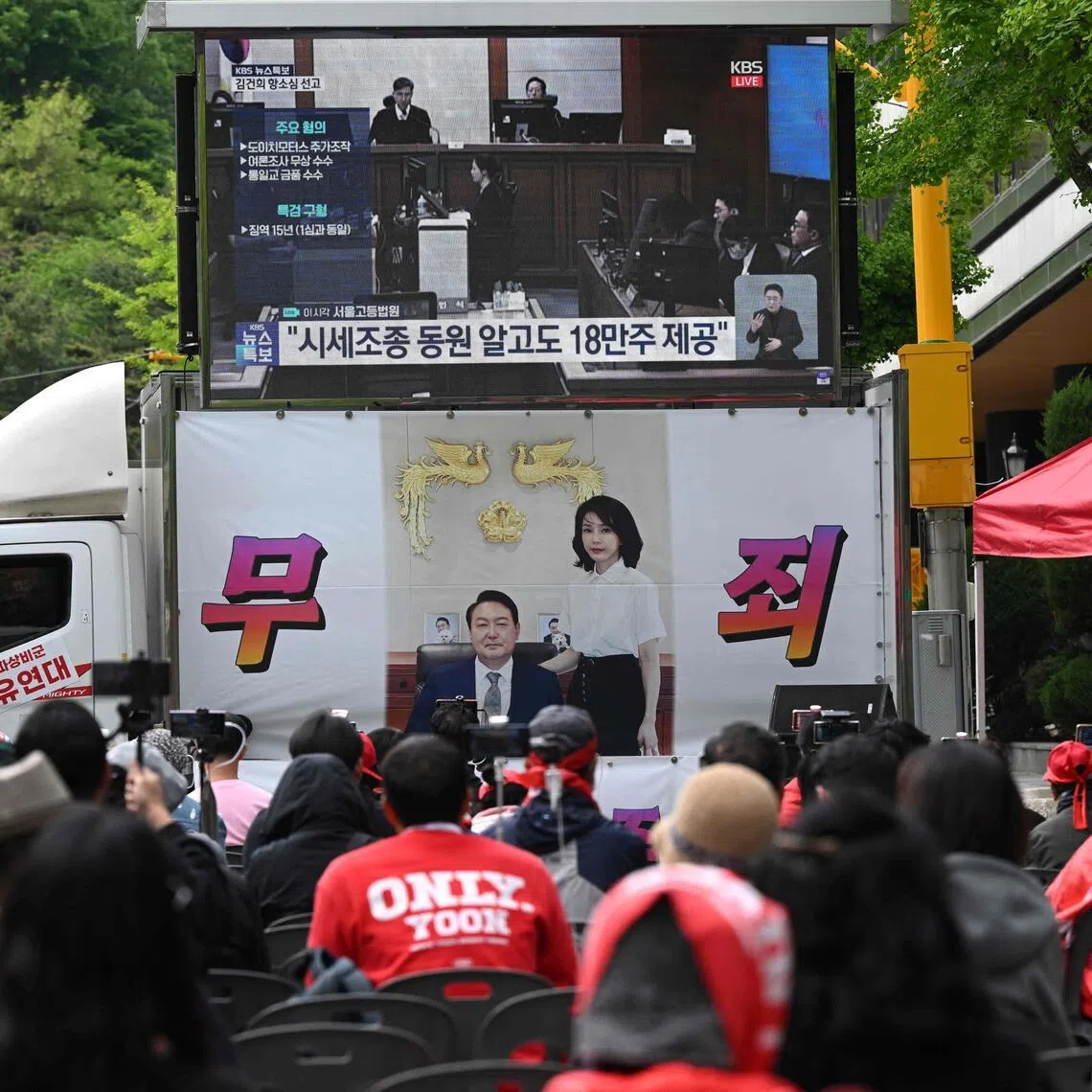 Supporters of former South Korean president Yoon Suk Yeol and his wife Kim Keon Hee watch a live stream of Kim's trial near the Seoul High Court on April 28.