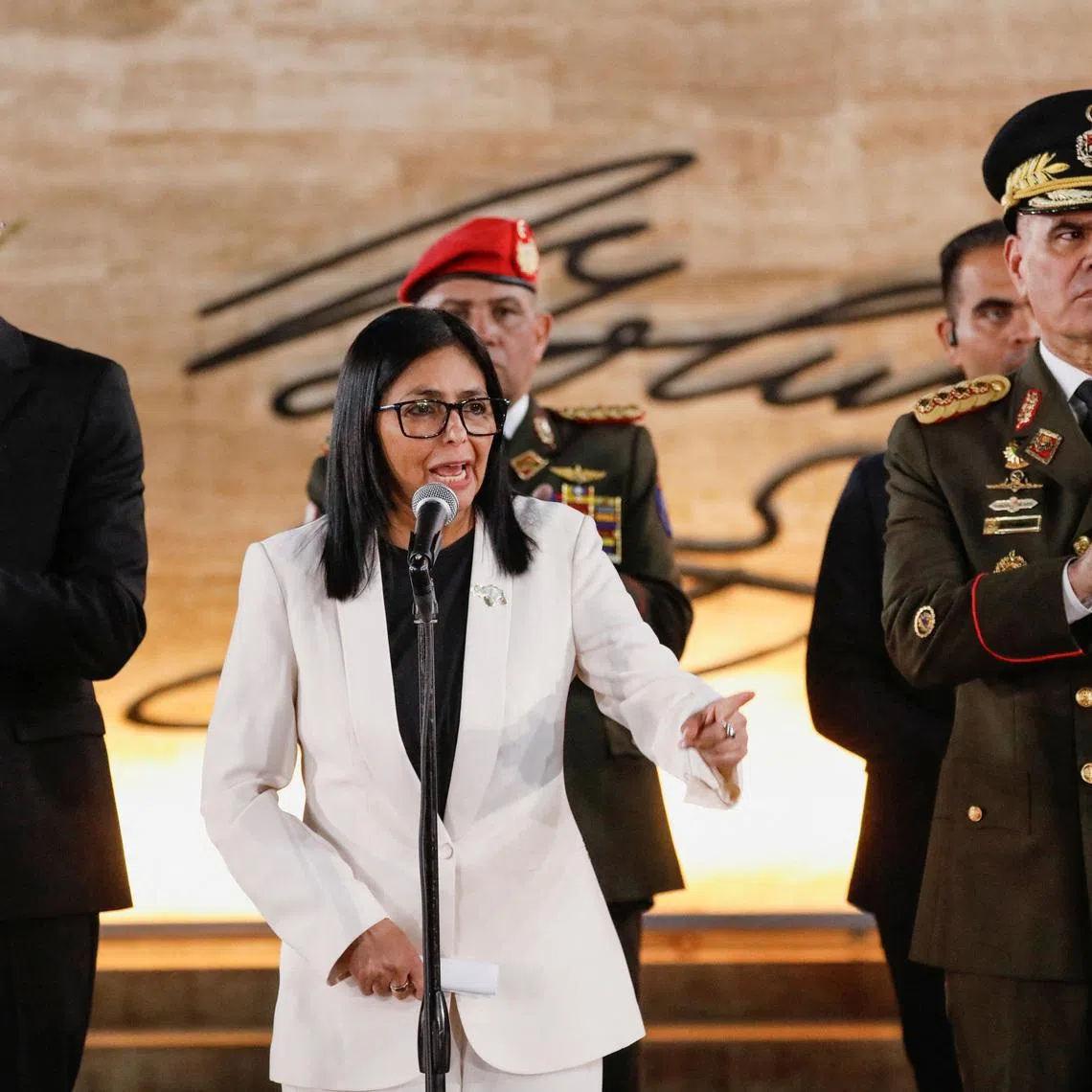 Venezuela's interim president Delcy Rodriguez, alongside Defence Minister Vladimir Padrino Lopez, delivers a speech, during the ceremony \"Promotions and Decorations for Heroes and Martyrs\", honouring Venezuelan and Cuban military and security personnel who died during a U.S. operation to capture Venezuela's President Nicolas Maduro and his wife Cilia Flores, in Caracas, Venezuela, January 8, 2026. REUTERS/Leonardo Fernandez Viloria