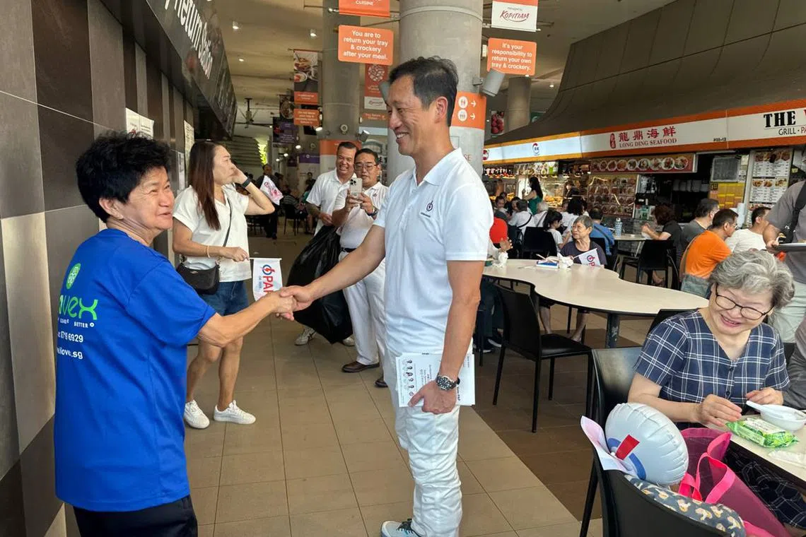 Health Minister Ong Ye Kung greeting a resident during a walkabout at Kampung Admiralty Hawker Centre on April 27.