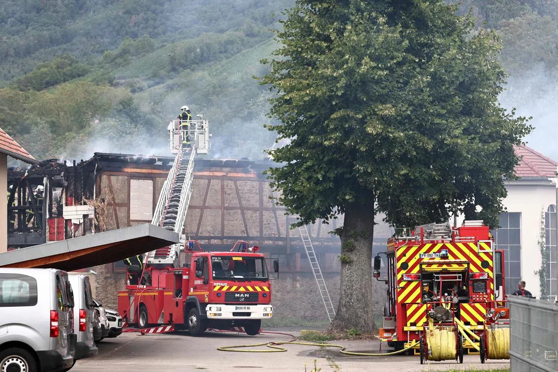 Firefighters work to extinguish a fire which erupted at a home for disabled people in Wintzenheim near Colmar, eastern France, on August 9, 2023. Seventeen people were evacuated and at least 11 are still reported missing. (Photo by Anne-Christine POUJOULAT / AFP)