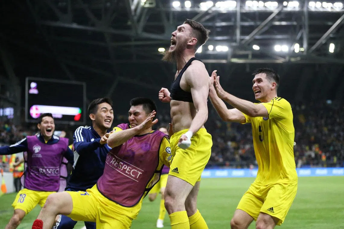 Kazakhstan's Abat Aimbetov celebrating after scoring a late winner in their 3-2 Euro 2024 qualifying triumph over Denmark on Sunday.
