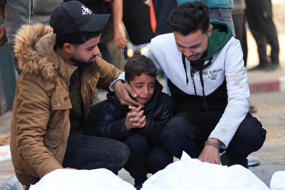 Mourners react as they attend the funeral of Palestinians who, according to medics, were killed in an Israeli strike on Tuesday, at Al-Shifa Hospital in Gaza City, December 3, 2025. REUTERS/Dawoud Abu Alkas
