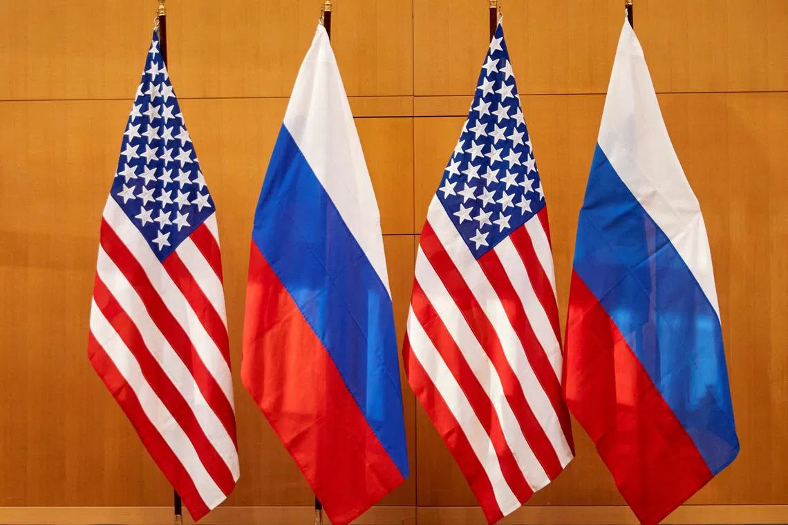 FILE PHOTO: Russian and U.S. flags are pictured at the United States Mission in Geneva, Switzerland January 10, 2022. REUTERS/Denis Balibouse/File Photo