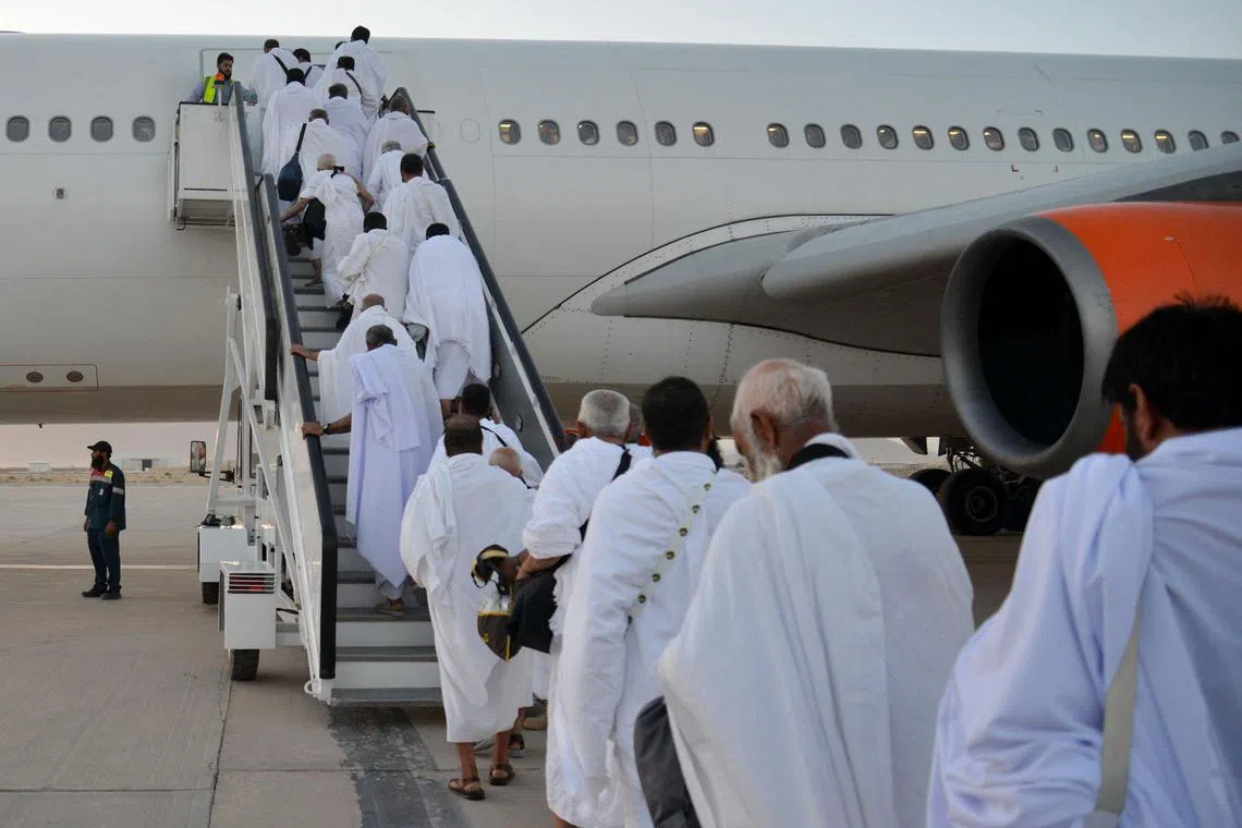 Afghan haj pilgrims boarding a plane to Saudi Arabia, at Kandahar airport on May 12.