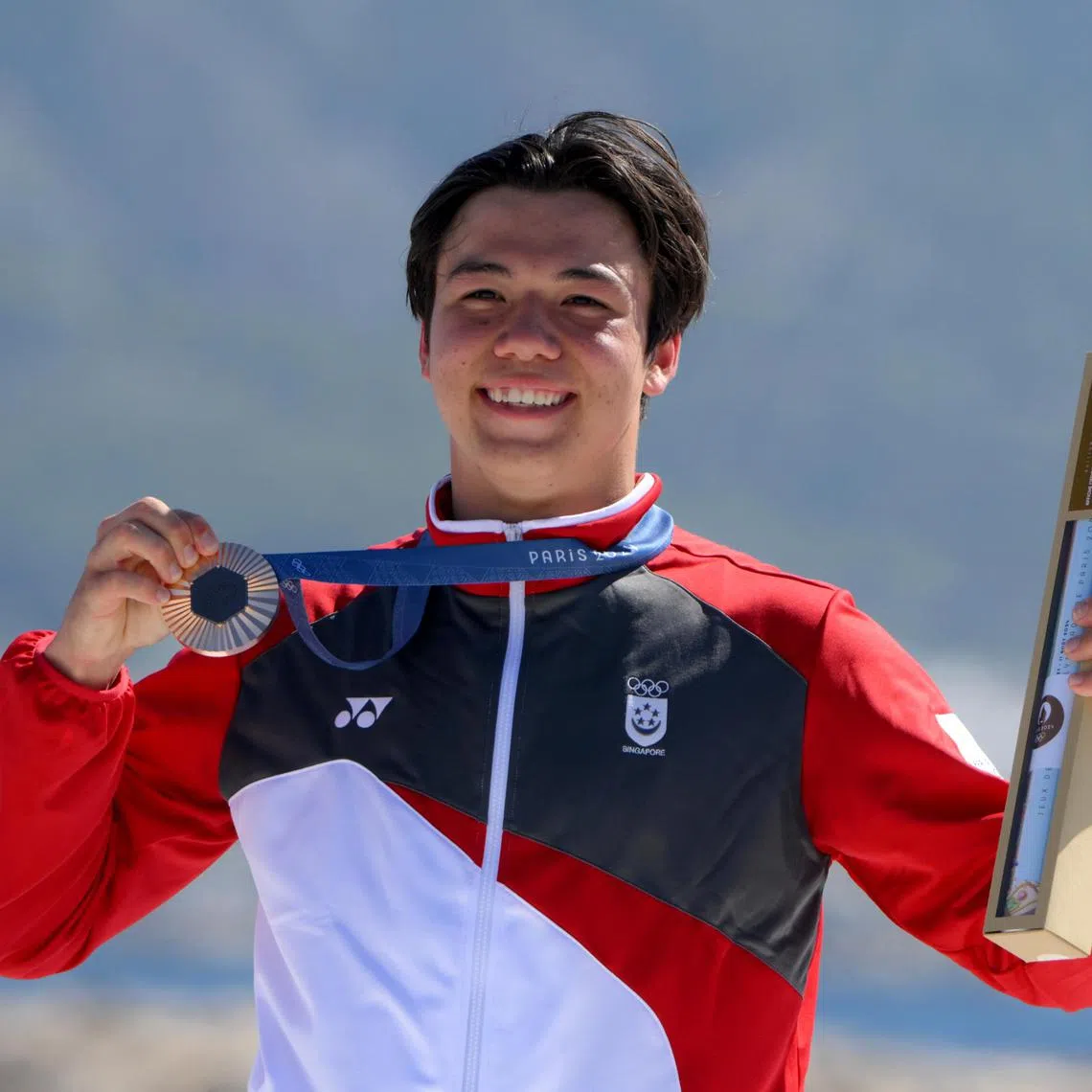 Singaporean Kitefoiler Maximilian Maeder with his bronze medal of the Paris 2024 Olympics Men’s Kite event at the Marseille Marina on August 9, 2024.