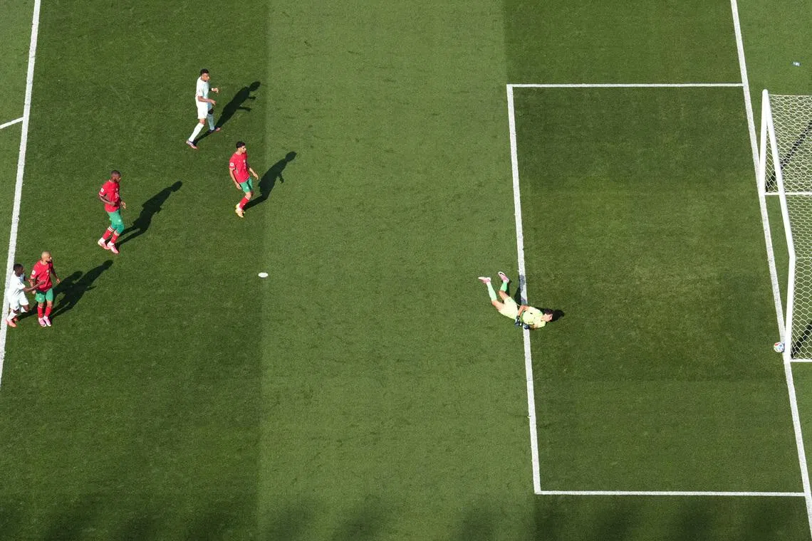 France’s Ousmane Dembele scores their second goal past Morocco’s Yassine Bounou.