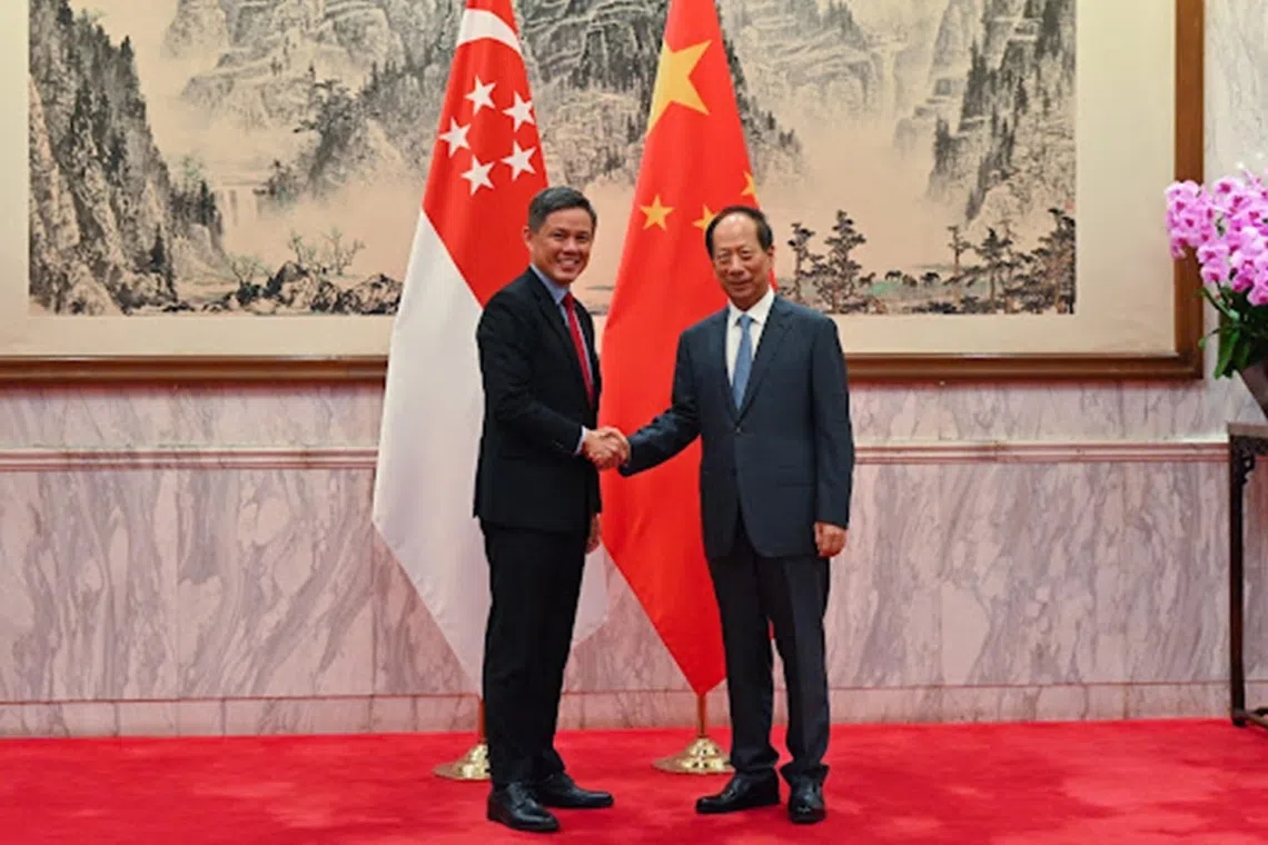 Defence Minister Chan Chun Sing with Mr Shi Taifeng , a member of the Political Bureau of the Communist Party of China (CPC) and Minister of the CPC Central Committee Organisation Department, in Beijing, on Sept 17.