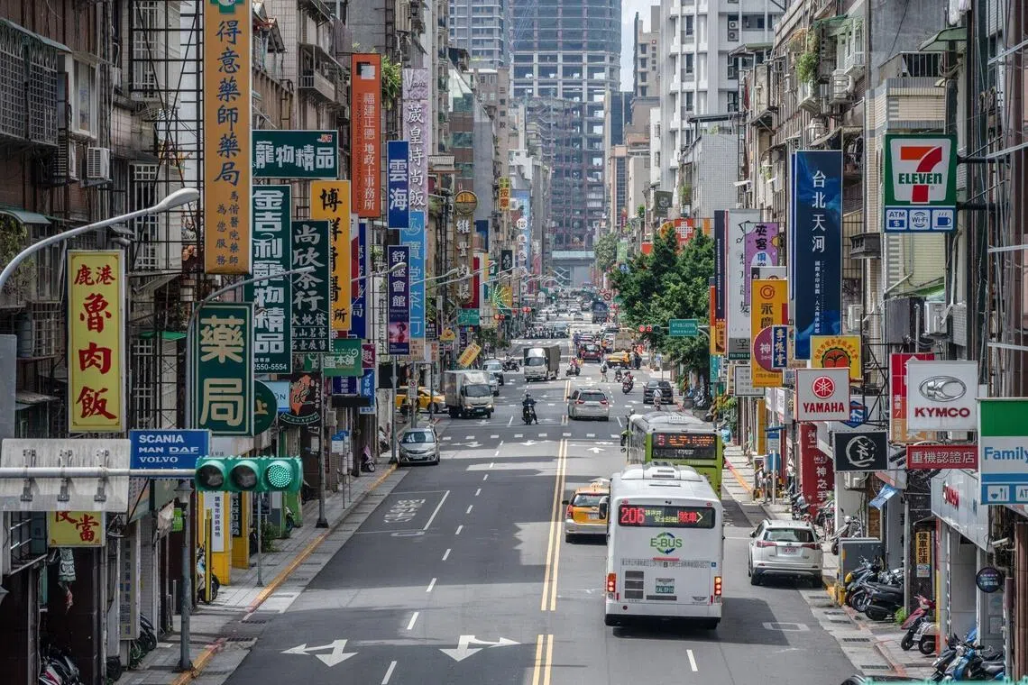 Store signs along a road in Taipei, Taiwan, on Thursday, July 16, 2026.