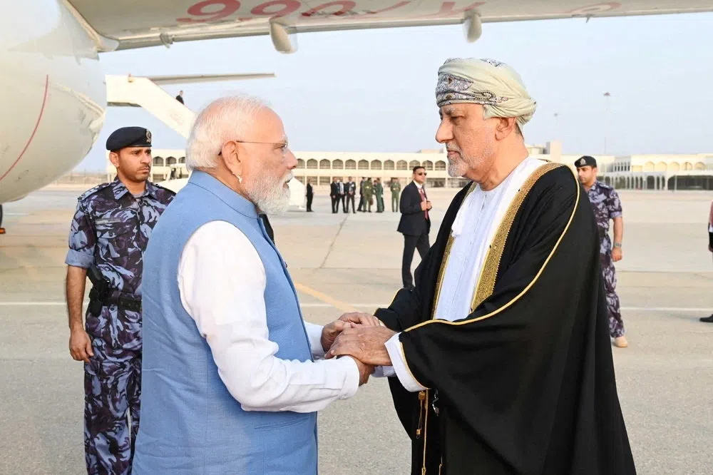 Oman's Deputy Prime Minister for Defence Affairs Sayyid Shihab bin Tariq Al Said welcomes Indian Prime Minister Narendra Modi upon his arrival in Muscat, Oman, December 17, 2025. Oman News Agency/Handout via REUTERS