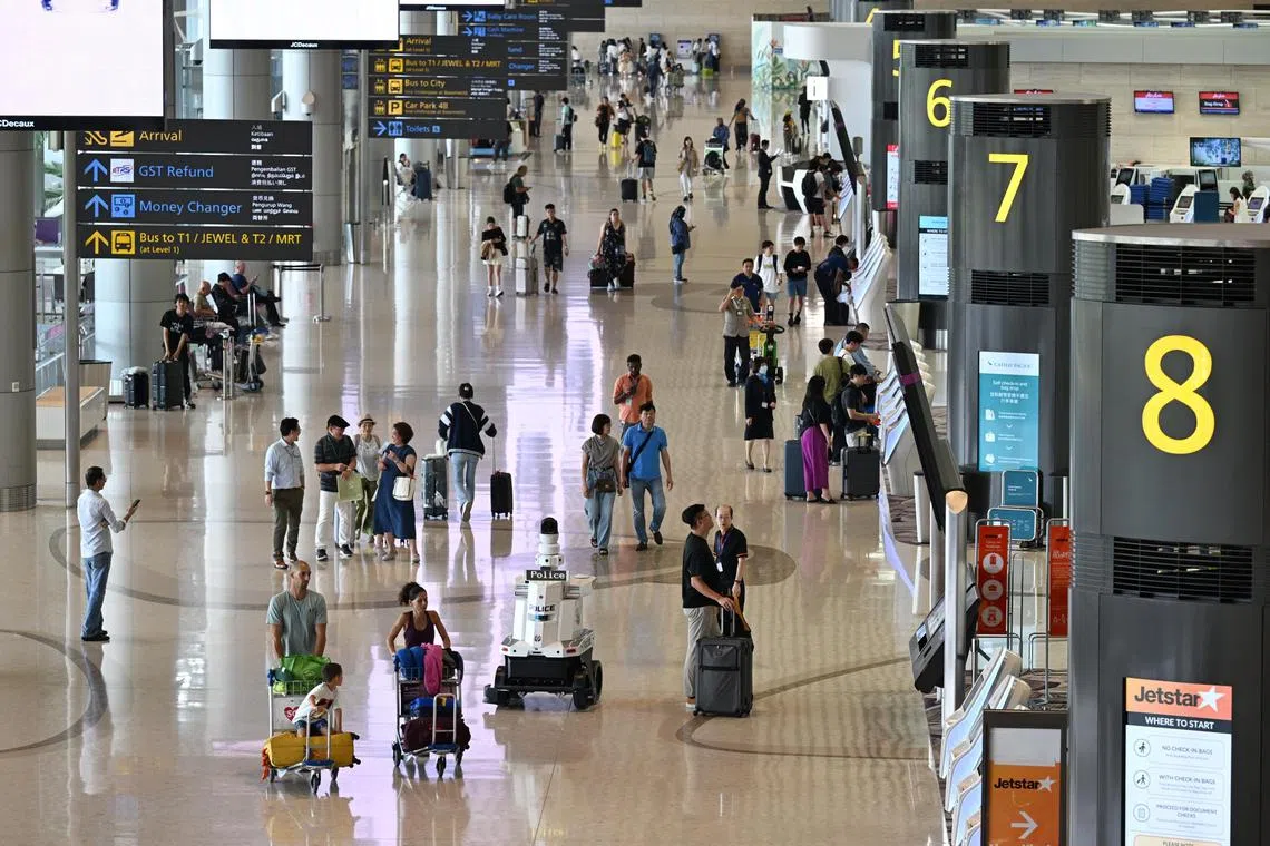Generic photo of passengers in the departure hall with a Police patrol robot at Changi Airport Terminal 4 taken on Oct 29, 2024.

Can be used for travel, airline, airfare stories.
