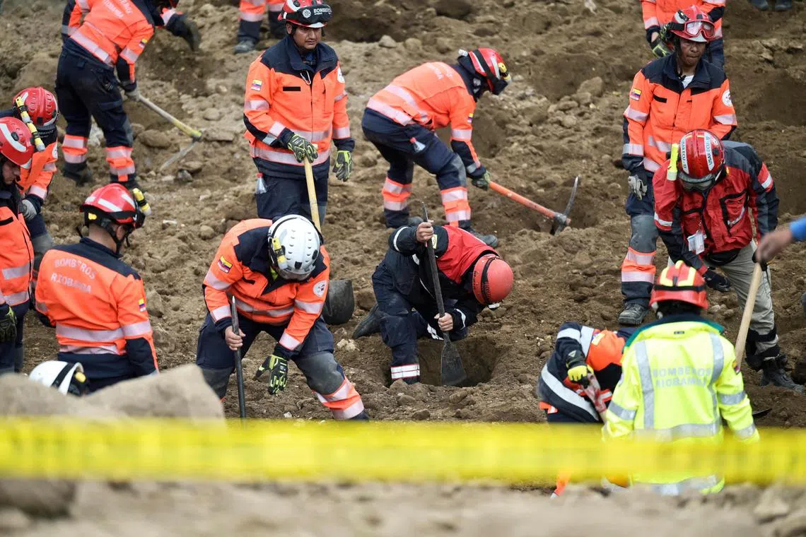 Rescue teams search for survivors after a landslide in Alausi, Ecuador, on March 28, 2023.