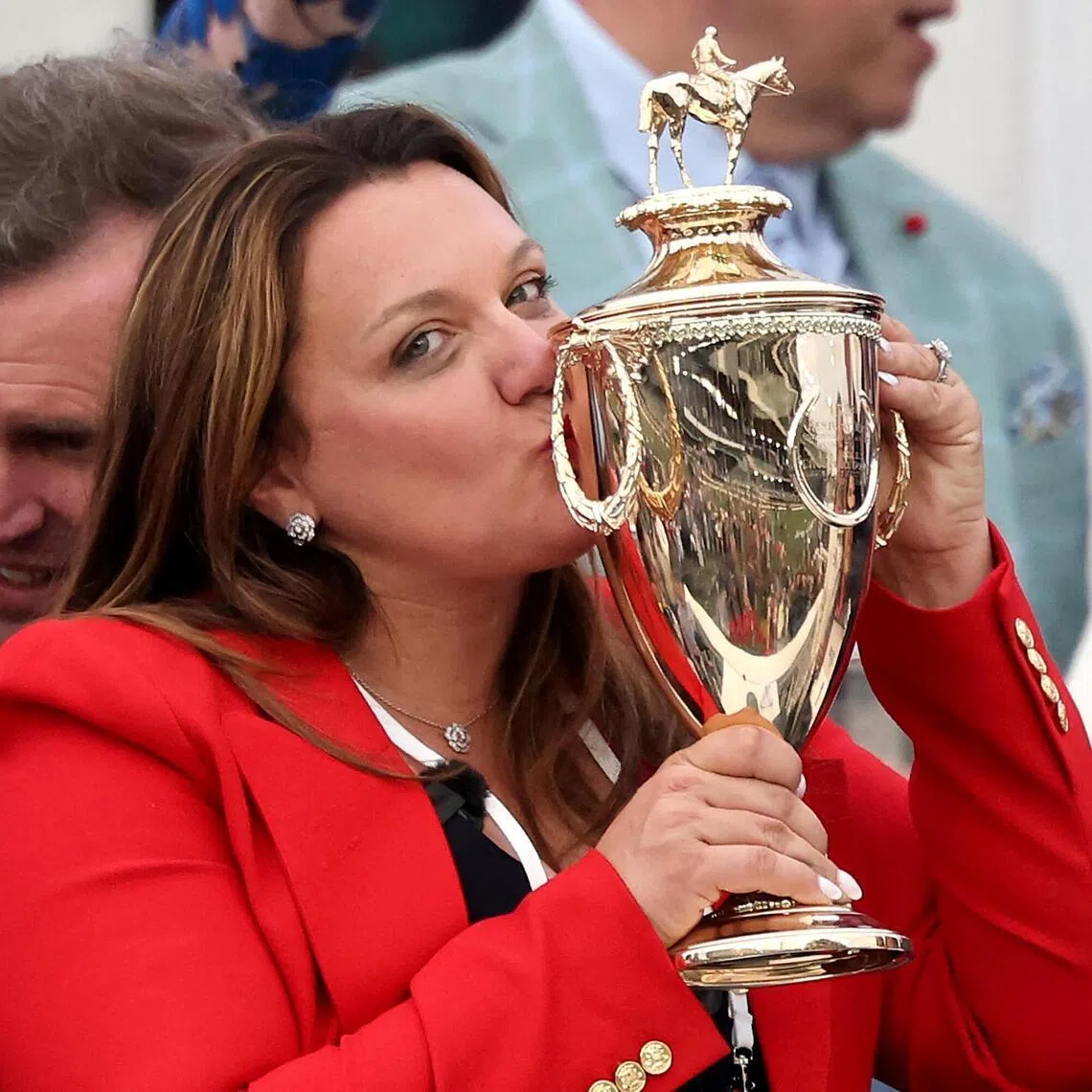 LOUISVILLE, KENTUCKY - MAY 02: Cherie DeVaux trainer of Golden Tempo #19, is the first female trainer to win the Kentucky Derby, celebrates with the trophy in the winner's circle following the 152nd running of the Kentucky Derby at Churchill Downs on May 02, 2026 in Louisville, Kentucky.   Michael Reaves/Getty Images/AFP (Photo by Michael Reaves / GETTY IMAGES NORTH AMERICA / Getty Images via AFP)