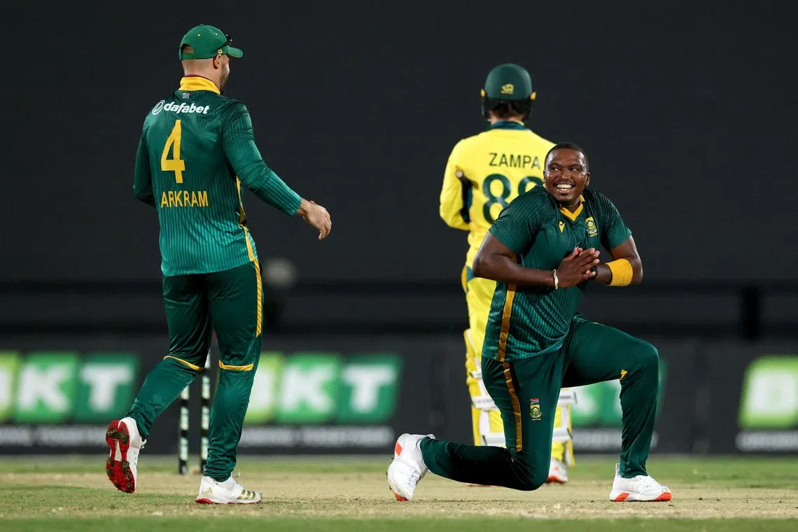 South Africa’s Lungi Ngidi celebrates with captain Aiden Markram after dismissing Australia’s Adam Zampa to win the second one-day international cricket match at the Great Barrier Reef Arena in Mackay on August 22, 2025.
