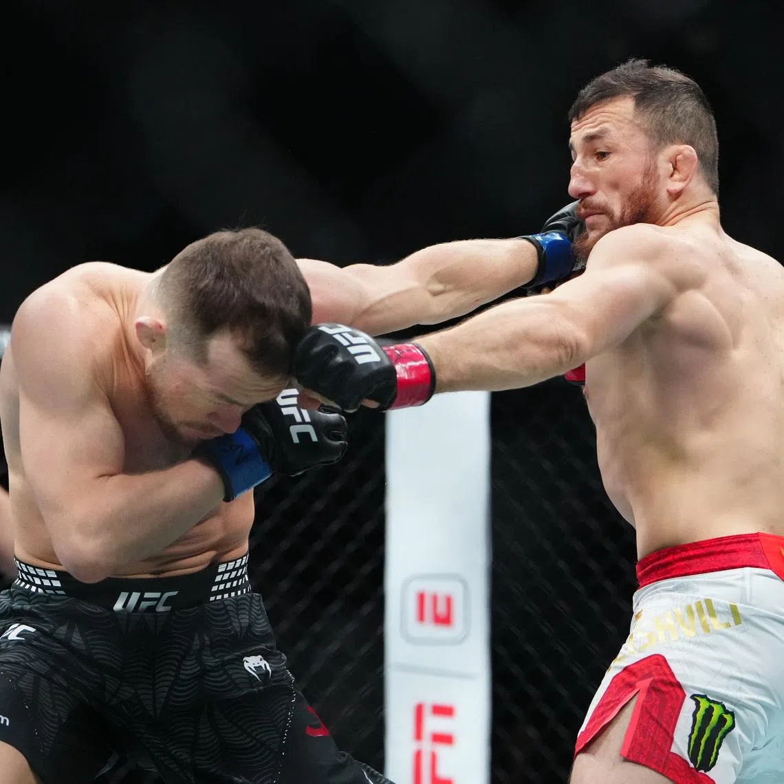 Dec 6, 2025; Las Vegas, Nevada, UNITED STATES; Merab Dvalishvili (red gloves) fights Petr Yan (blue gloves) during UFC 323 at T-Mobile Arena. Mandatory Credit: Stephen R. Sylvanie-Imagn Images