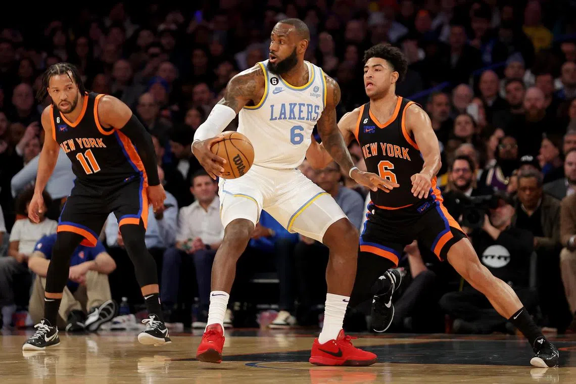 Los Angeles Lakers forward LeBron James trying to get past New York Knicks guards Quentin Grimes (No. 6) and Jalen Brunson at the Madison Square Garden.
