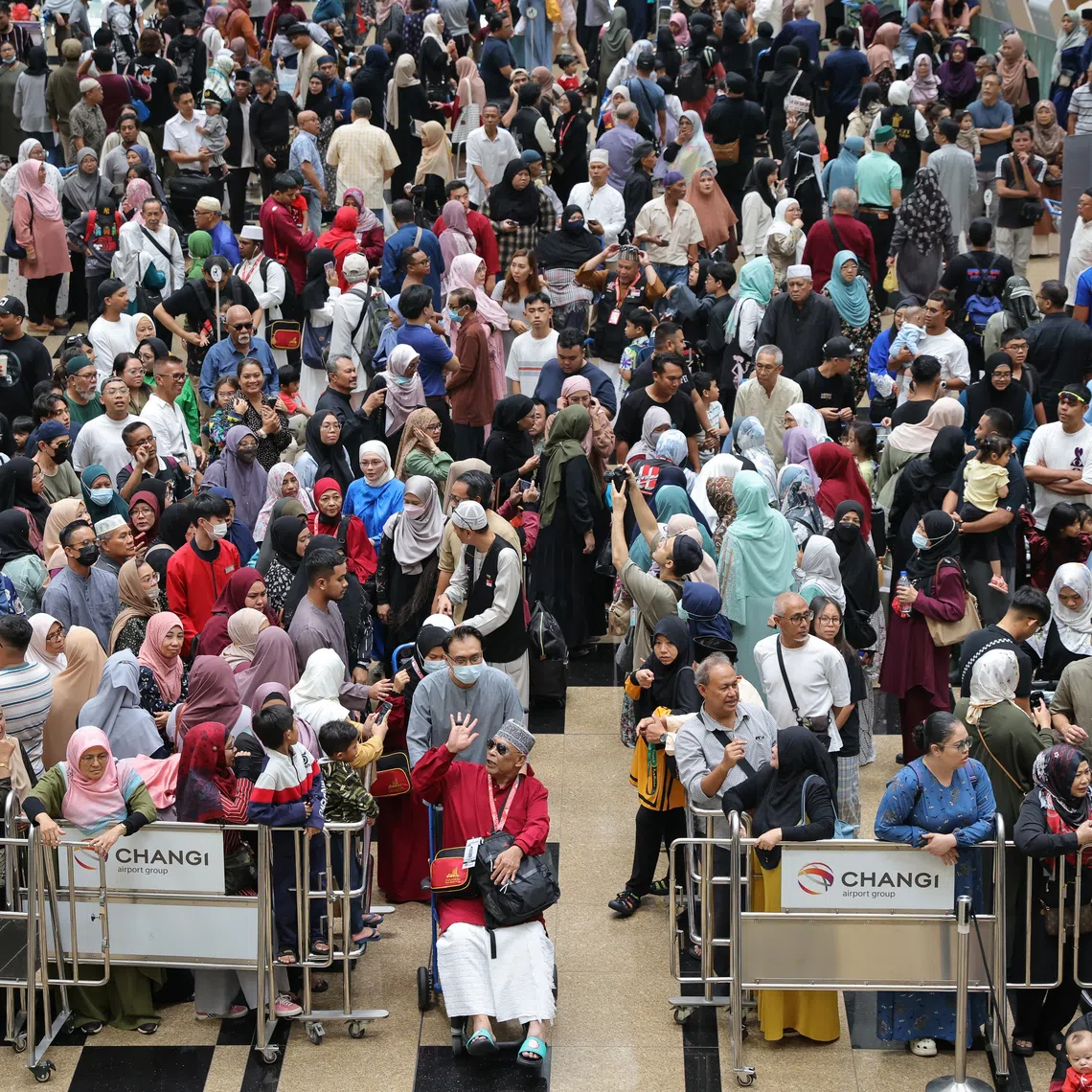Haj pilgrims saying their farewell to their family and friends before departing for Jeddah at Changi Airport in June 2023.