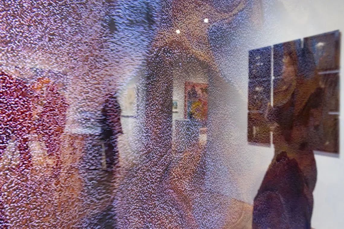 epa11911252 A person is reflected in the work 'Machine Hallucinations - ISS Dreams - A (i),' an AI-driven data painting by artist Refik Anadol at the ongoing exhibit for the 'Augmented Intelligence' auction at Christie's auction house in New York, New York, USA, 20 February 2025. All of the works in the auction, which will be taking place online from 20 February until 05 March, were created by or with the use of some form of artificial intelligence.  EPA-EFE/JUSTIN LANE